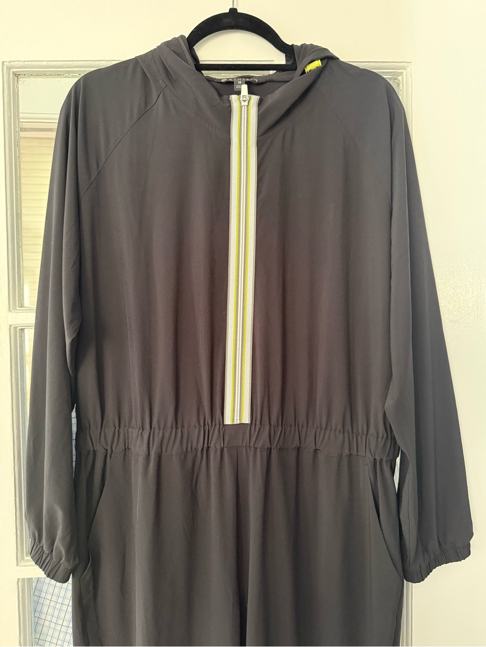 NWT Athleta Dipsea Romper .
Black  Hooded Jumpsuit with Yellow-Trim Zipper